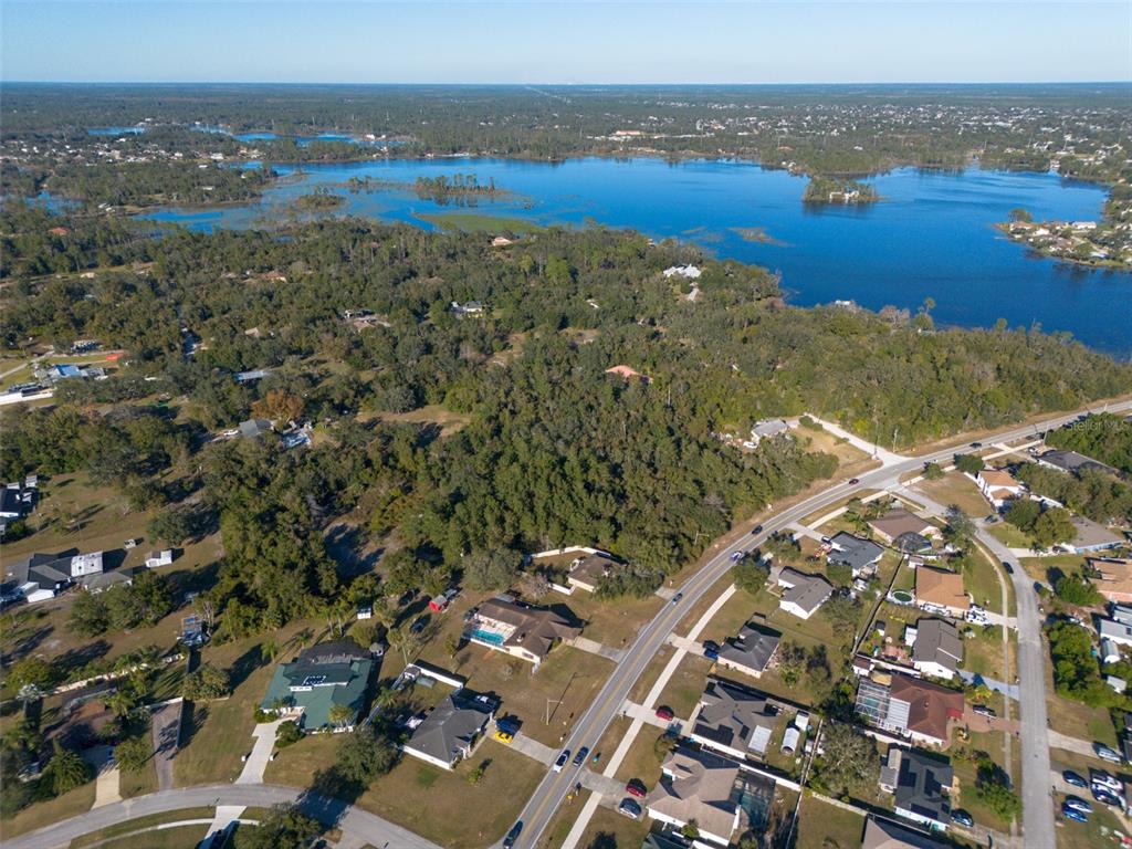 2078 Elkcam Boulevard Deltona, FL 32725 - Photo 26 of 36 an aerial view of a house with a lake view