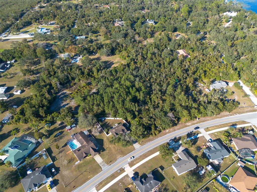 2078 Elkcam Boulevard Deltona, FL 32725 - Photo 4 of 36 a view of a yard with wooden fence