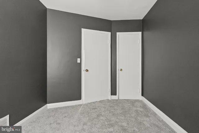 a view of a backyard with sitting area and tree