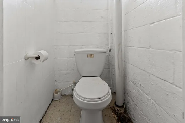 a bathroom with a sink a toilet and a window