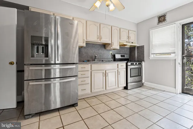 a kitchen with cabinets appliances and a sink