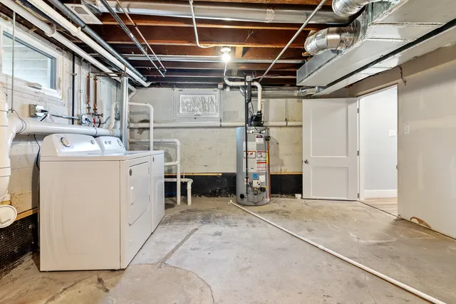 a kitchen with stainless steel appliances granite countertop a refrigerator a sink dishwasher a stove and white countertops with wooden floor