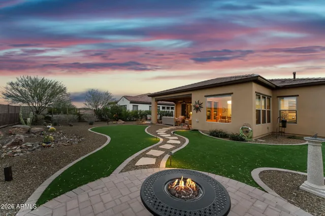 a kitchen with stainless steel appliances a dining table chairs and wooden floor