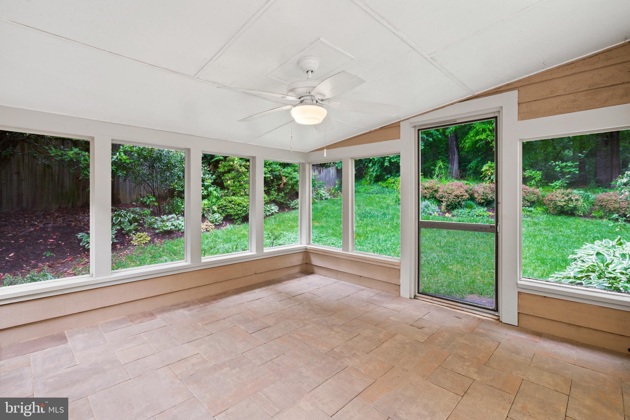 7805 Laurel Leaf Drive Potomac, MD 20854 - Photo 7 of 13 a view of an empty room with wooden floor and a floor to ceiling window