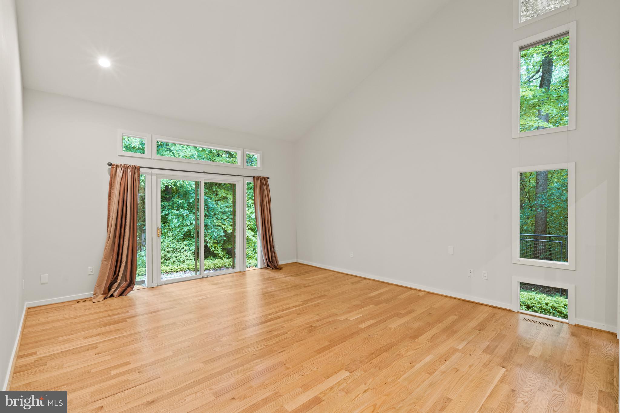 7805 Laurel Leaf Drive Potomac, MD 20854 - Photo 9 of 13 a view of an empty room with wooden floor and a window