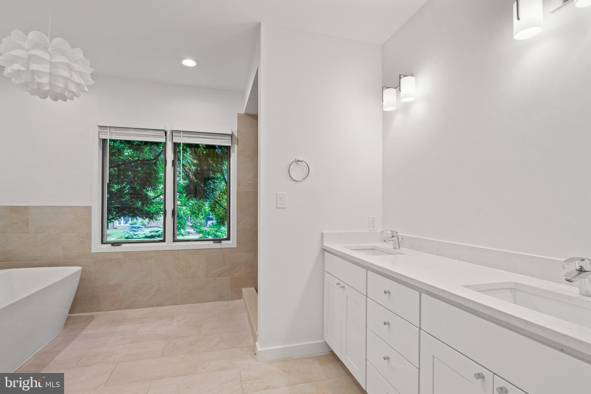 7805 Laurel Leaf Drive Potomac, MD 20854 - Photo 10 of 13 a spacious bathroom with a tub sink and mirror