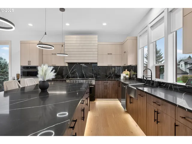 a kitchen with stainless steel appliances kitchen island granite countertop a sink and cabinets