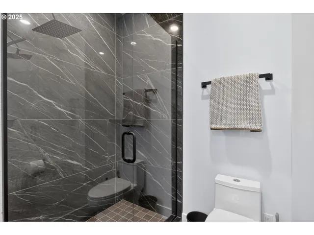 a bathroom with a toilet and a shower