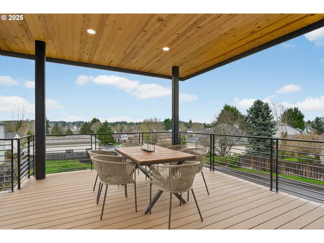 a view of a balcony with table and chairs