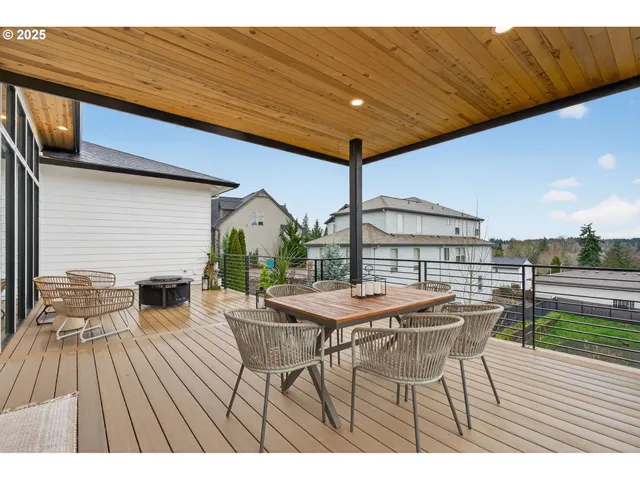 a view of a patio with table and chairs with wooden floor