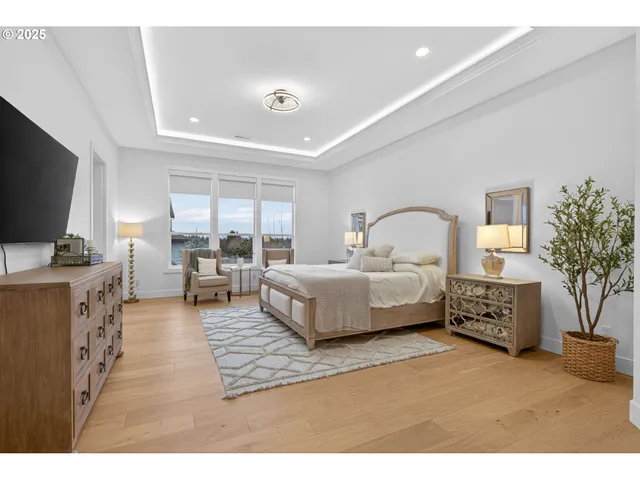 a bedroom with furniture and a flat screen tv