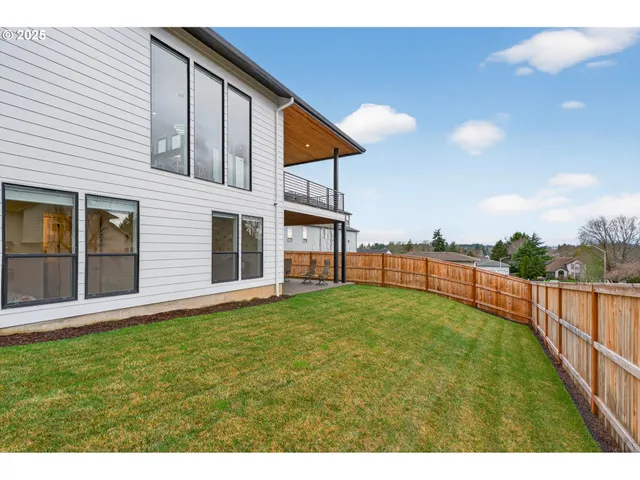 a view of an house with backyard and porch