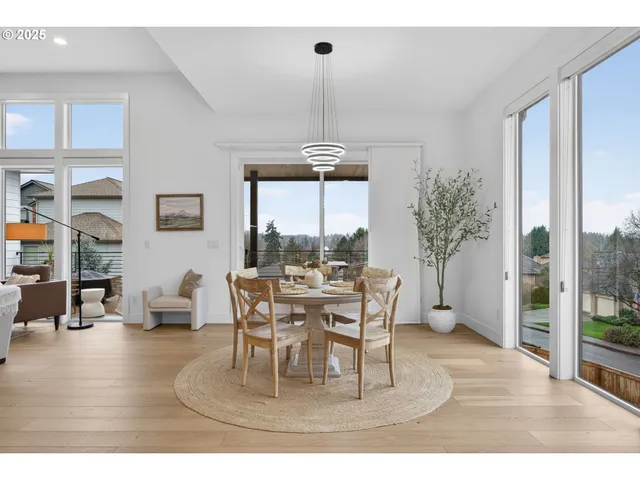 a dining room with furniture window and wooden floor