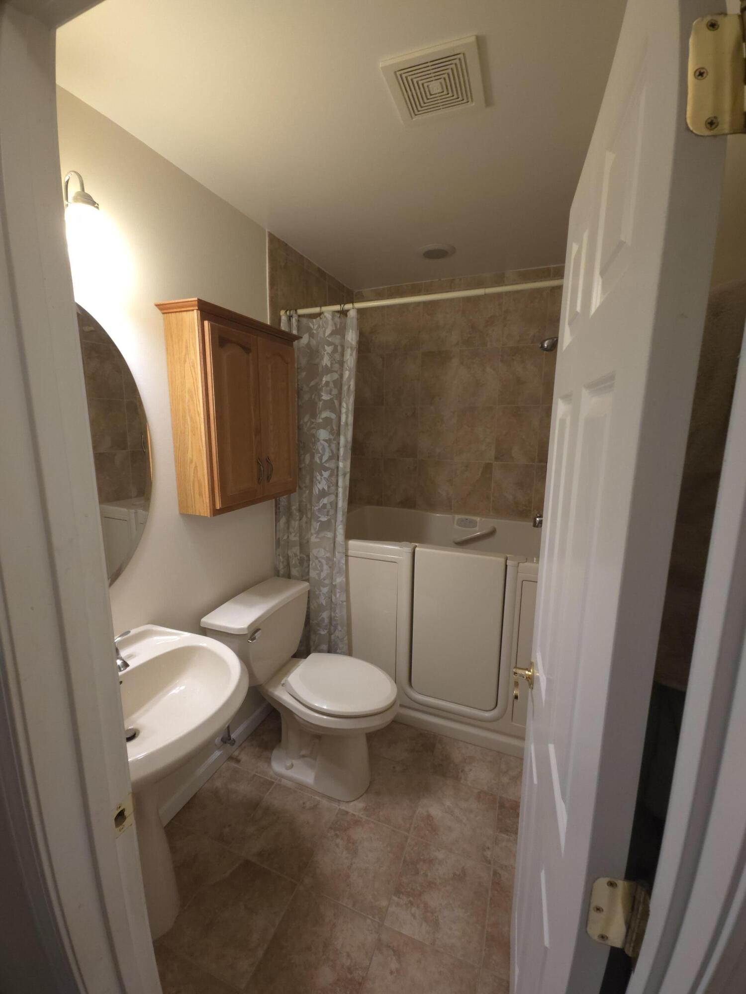 714 Governor Road Valparaiso, IN 46385 - Photo 4 of 15 a white toilet sitting next to a bathroom sink and a shower