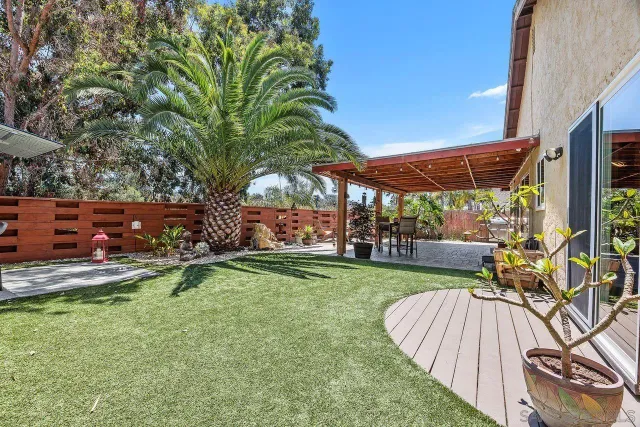 a view of a swimming pool with a patio and a yard