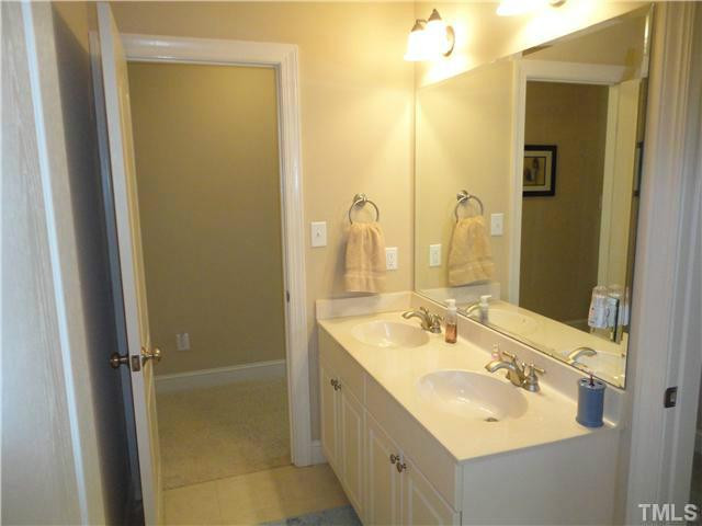 8410 Wheatstone Lane Raleigh, NC 27613 - Photo 16 of 25 One vanity side of Jack & Jill - dual vanity, marble counter tops, tile floors, brushed nickel fixtures. Bathroom