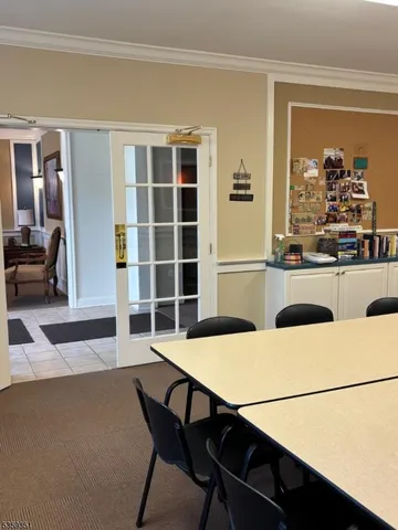 a living room with a table and chairs in it
