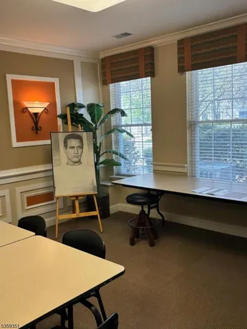 a room with furniture pool table and windows