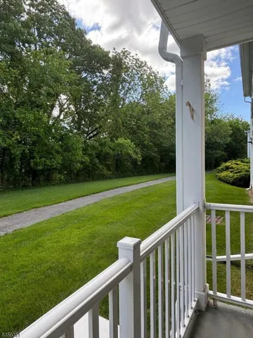 a view of a wooden deck and a backyard