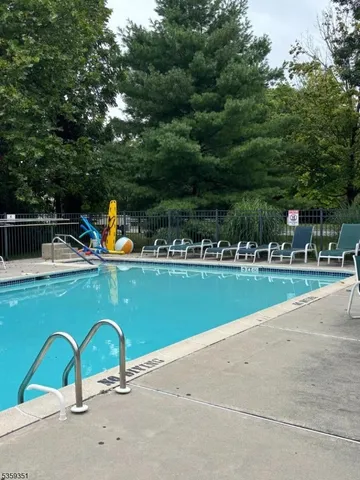 a view of a swimming pool with a yard and seating area