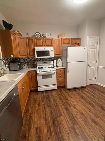 a kitchen with a sink appliances and cabinets