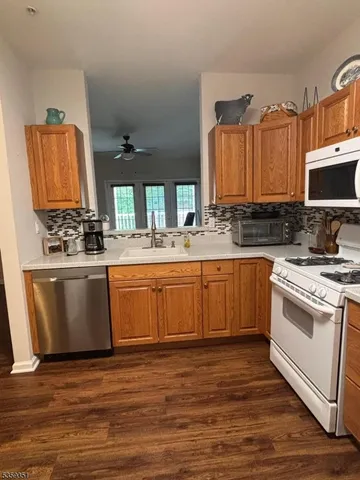 a kitchen with a stove a sink and a microwave