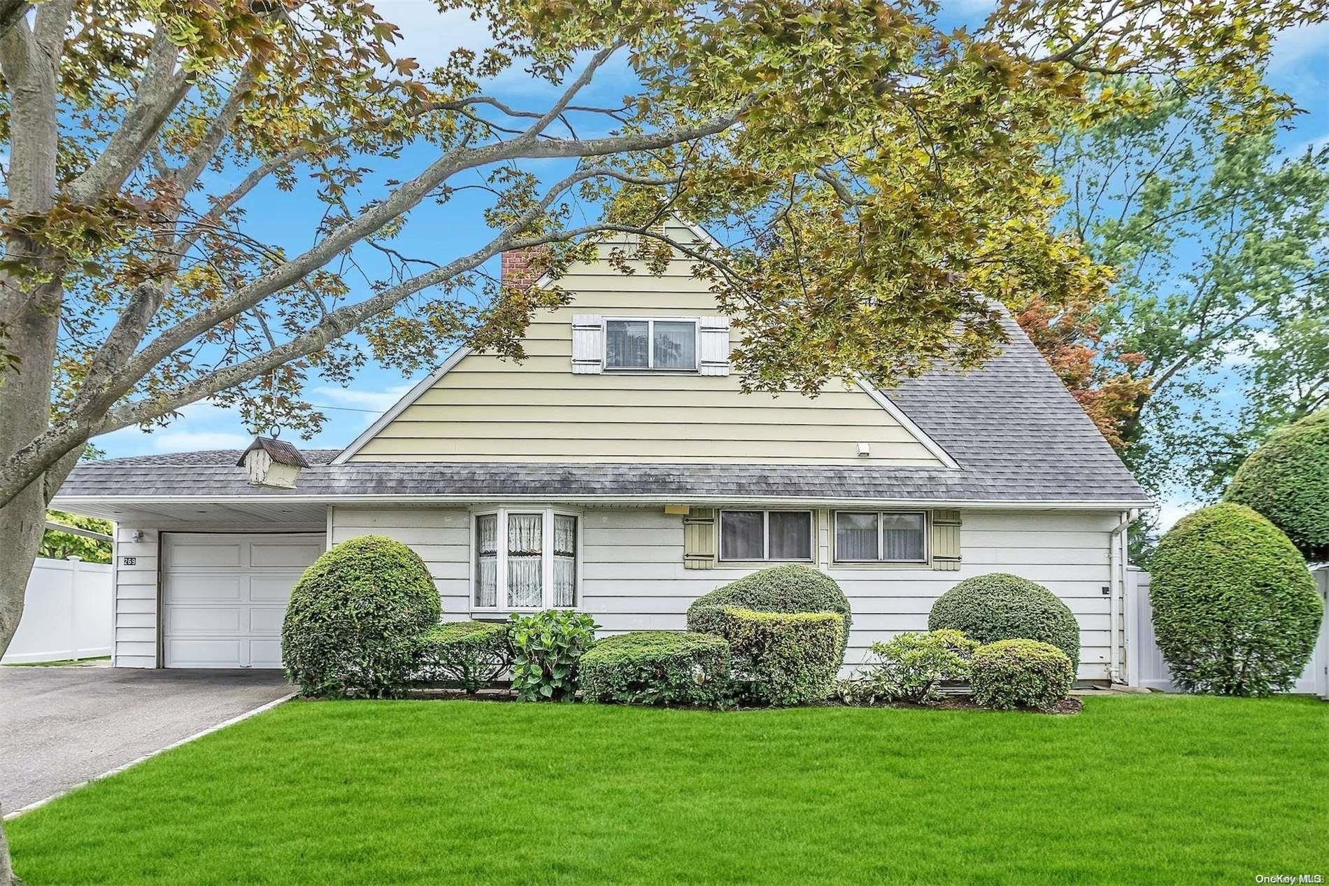 269 Blacksmith Road Levittown, NY 11756 - Photo 1 of 1 a front view of a house with a garden