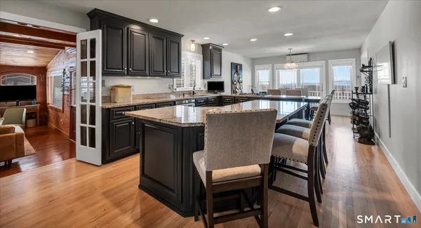 a kitchen with granite countertop sink stove and cabinets