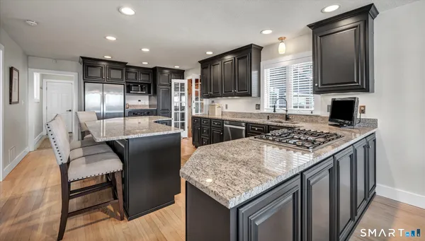 a view of a dining room with furniture wooden floor and chandelier