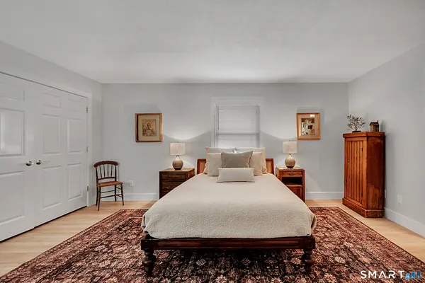 a bedroom with a bed a couch and dresser