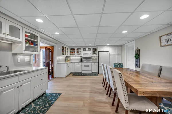 a living room with furniture and view of kitchen