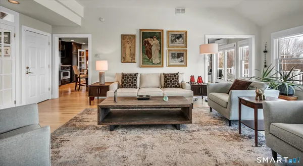 a living room with furniture large window and a fireplace