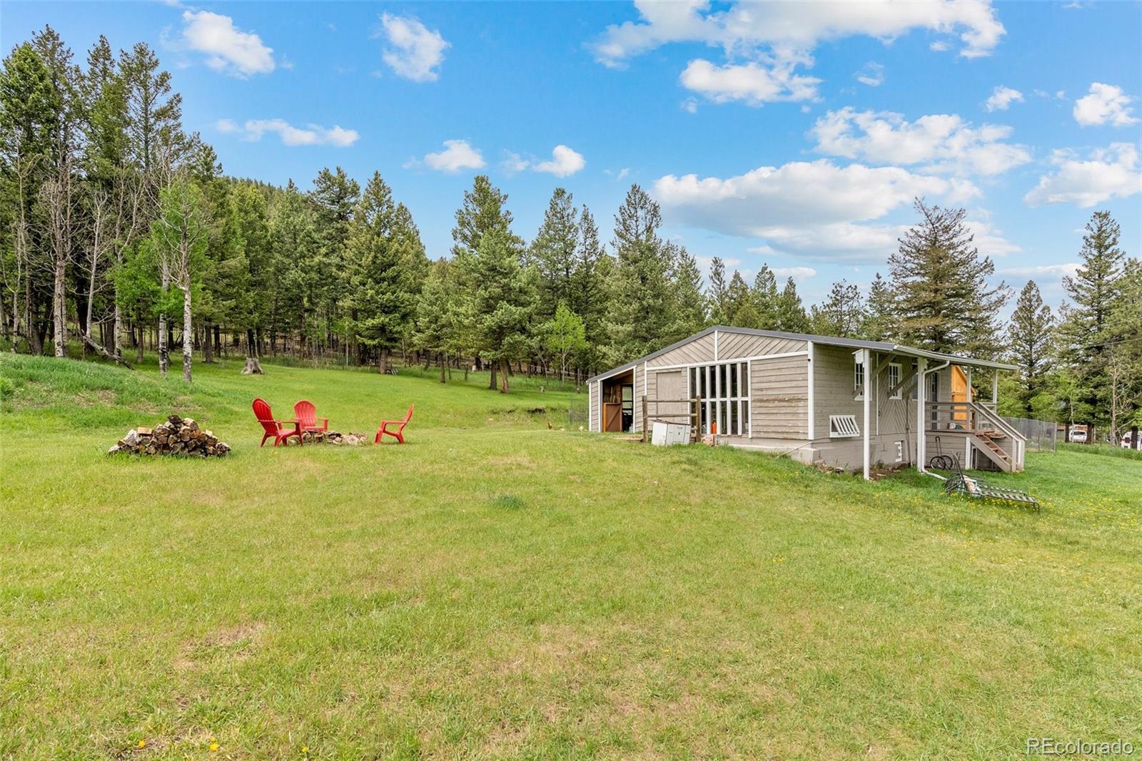 795 Burland Drive Bailey, CO 80421 - Photo 25 of 50 a backyard of a house with table and chairs