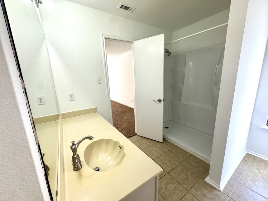 2009 Marysol Trail Cedar Park, TX 78613 - Photo 12 of 15 Full bath with vanity, light tile patterned floors, and a shower stall