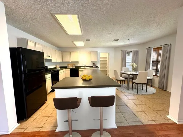 a kitchen with a dining table and chairs