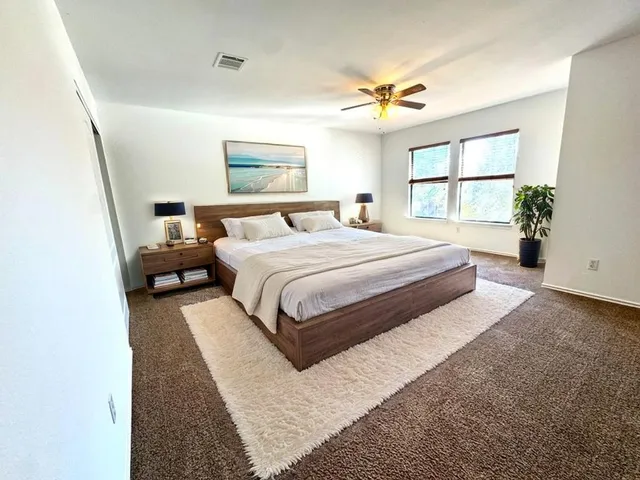 a bedroom with a large bed and a window