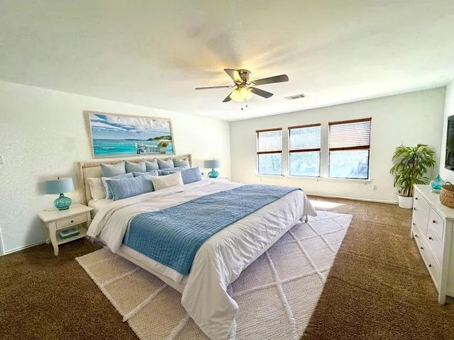 a bedroom with a large bed and a window