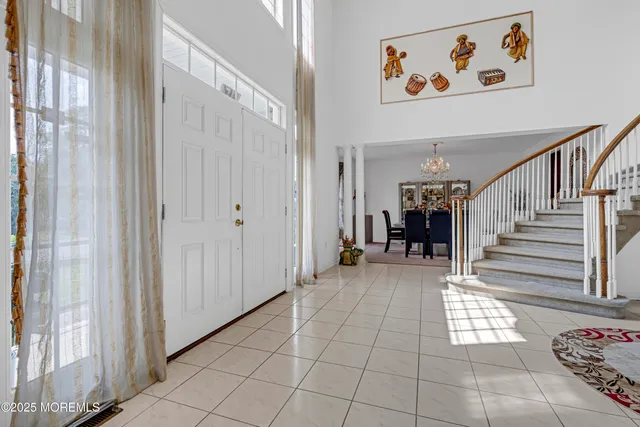 a view of a dining room with furniture and chandelier