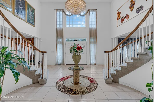 a view of a dining room with furniture and chandelier