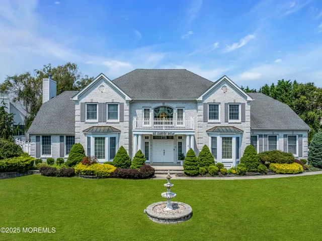 a front view of a house with a yard table and chairs