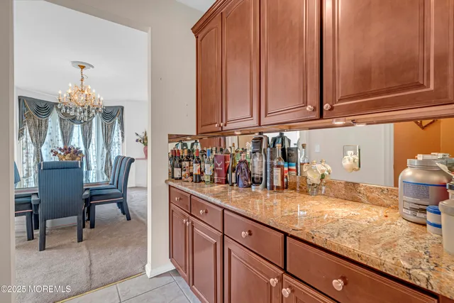 a kitchen with stainless steel appliances granite countertop a stove refrigerator and cabinets
