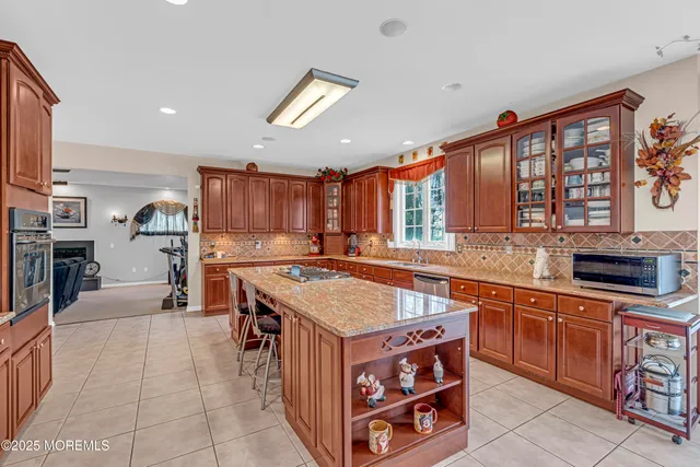 a kitchen with stainless steel appliances granite countertop a sink stove and microwave
