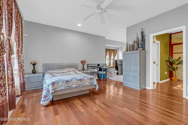 a bedroom with a bed a desk and chair