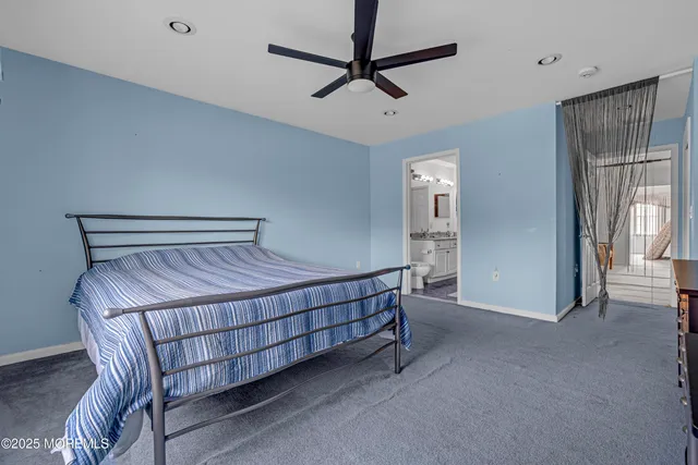 a bed room with a bed a television and a large window