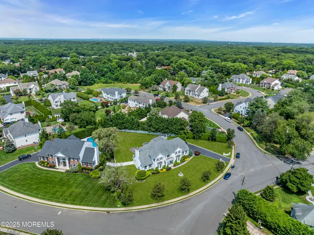 an aerial view of a house with outdoor space and garden