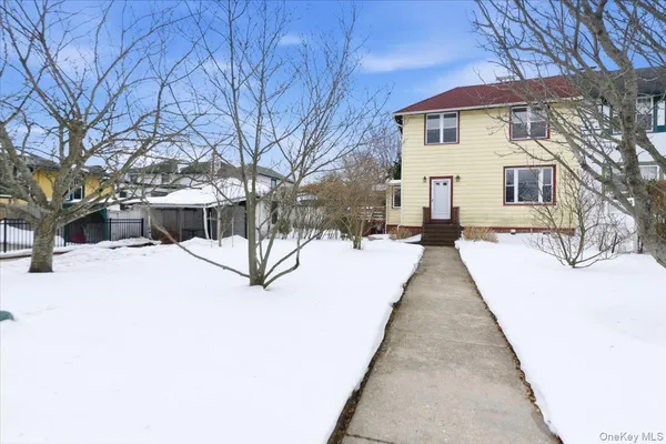 a view of house with a yard covered in snow