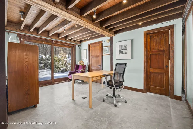 a dining room with furniture and a window
