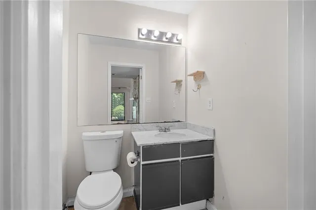 a bathroom with a sink toilet and mirror