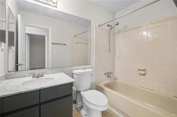 a bathroom with a sink toilet vanity and shower