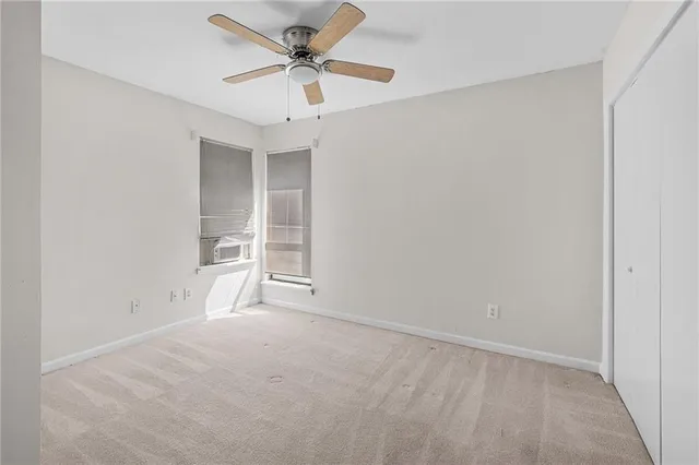 an empty room with a empty space and a ceiling fan